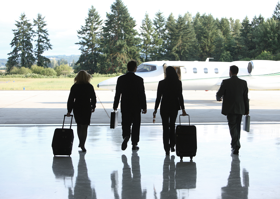 Group of businesspeople walking to corporate jet